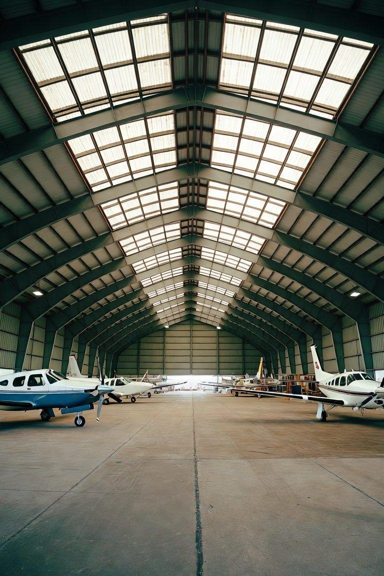 Inside a maintenance hangar with based aircraft under the skylights